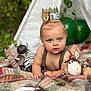 baby, child, one_year_old, birthday_crown, plush_toys, elephant_toy, zebra_toy, giraffe_toy, lion_toy, blanket, teepee, balloons, outdoor, greenery, portrait, cute, infant, celebration, happy, toddler