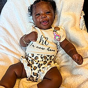 Remedy is registered to the contest to win money with this photo: baby, smiling, infant, cute, blanket, clothing, leopard_print, bracelet, pacifier_clip, happy, lying_down, socks, cute_hairstyle, face, person, child, indoors, soft_texture, white_blanket, adorable