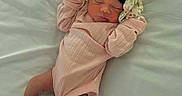 Natalie is registered to the contest to win money with this photo: ankle_band, baby, bed, bow, cute, floral_pattern, headband, hospital_band, infant, mittens, newborn, newborn_baby, peaceful, pink_onesie, portrait, skin, sleeping, soft_light, tiny_feet, white_sheets