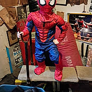 Donnavee is registered to the contest to win money with this photo: child, spider_man, costume, superhero, masked, cosplay, red, blue, standing, posing, indoors, bench, training_bar, boxing_equipment, gym, posters, cluttered_room, portrait, action_pose, playful