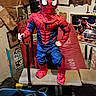 action_pose, bench, blue, boxing_equipment, child, cluttered_room, cosplay, costume, gym, indoors, masked, playful, portrait, posing, posters, red, spider_man, standing, superhero, training_bar