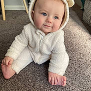Andrew joined the competition — help win amazing prizes! baby, infant, child, onesie, white_clothing, carpet, indoor, cute, smiling, foot, hand, face, blue_eyes, fur_texture, hood, ears, cozy, soft, seated, playful