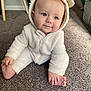 baby, infant, child, onesie, white_clothing, carpet, indoor, cute, smiling, foot, hand, face, blue_eyes, fur_texture, hood, ears, cozy, soft, seated, playful
