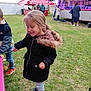 casual_clothing, child, coat, daytime, fair, festival, fun, game_stall, girl, grass, happy, hood, leisure, marshmallow, outdoor, people, smile, stick, stuffed_animals, tent