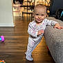 Audri joined the competition — help win amazing prizes! toddler, child, pajamas, smile, indoor, couch, wooden_floor, toy, face, person, home, furniture, baby, floor, hand, clothing, leaning, happy, cute, living_room
