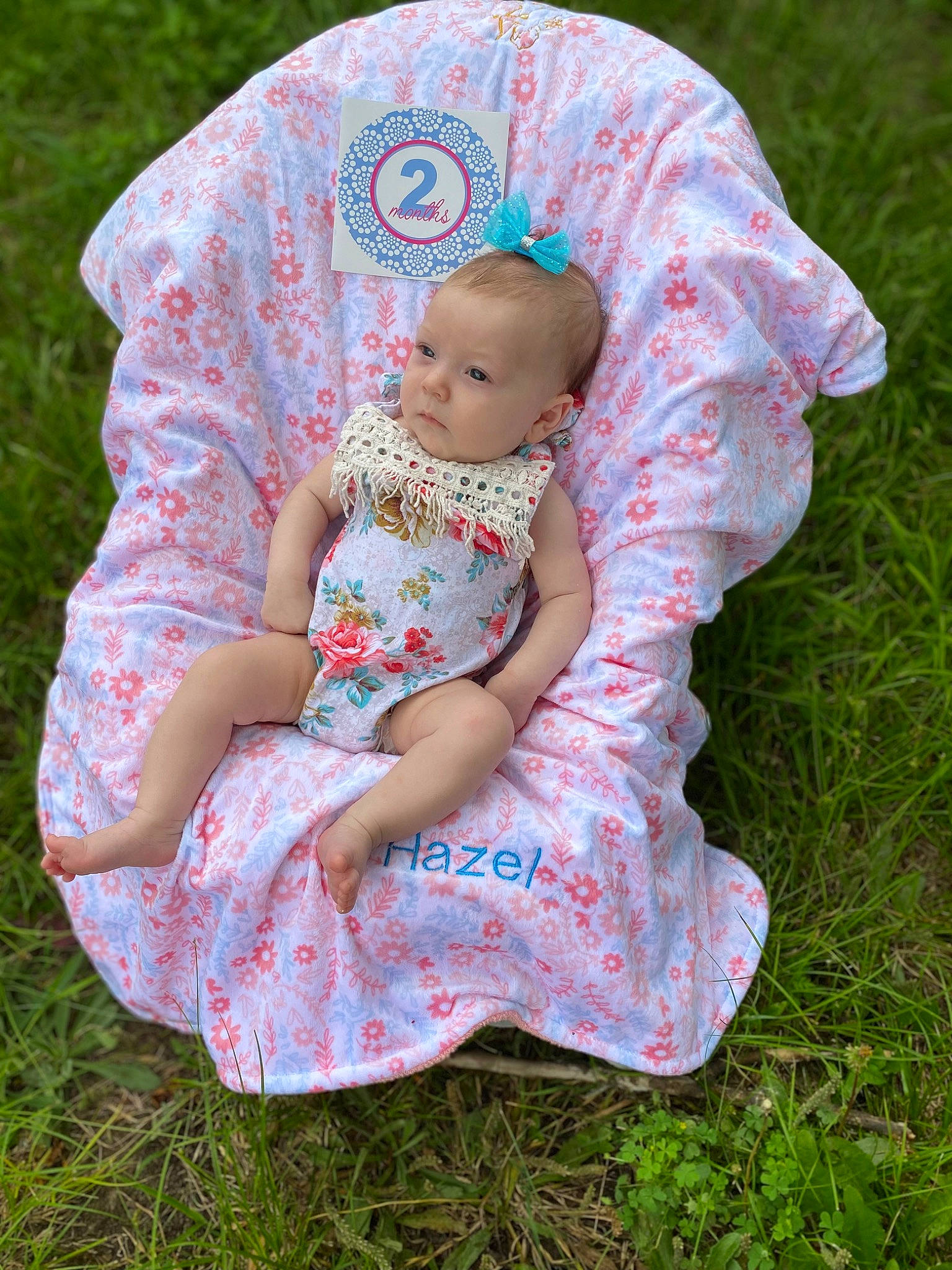Hazel is registered to the contest to win money with this photo: baby, baby_toddler_clothing, child, dress, grass, grass_family, hand, human_body, lawn, leaf, magenta, pattern, people_in_nature, person, pink, recreation, sitting, sleeve, t_shirt, textile