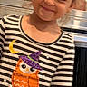 Alianna is registered to the contest to win money with this photo: child, girl, toddler, smiling, portrait, indoors, kitchen, striped_shirt, costume, halloween, owl, witch_hat, purple_skirt, orange, purple, bow, long_sleeves, blonde_hair, appliance, happy