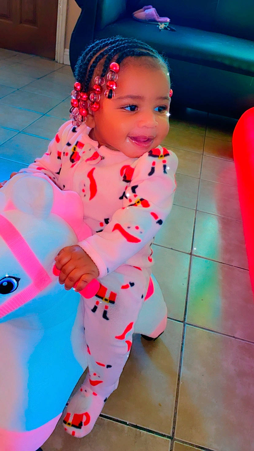 Kamiah is registered to the contest to win money with this photo: baby, baby_products, baby_toddler_clothing, child, costume, floor, hair_accessory, happy, headband, joy, nightwear, nose, overall, pajamas, person, pink, play, tile, toddler