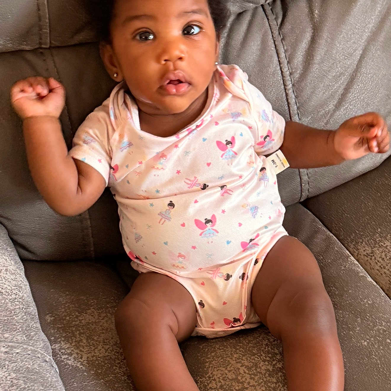 Ta Sanai joined the competition — help win amazing prizes! baby, infant, child, onesie, couch, sofa, earrings, curly_hair, cute, chubby, relaxed, indoor, portrait, comfort, skin, feet, arms, legs, looking, expression