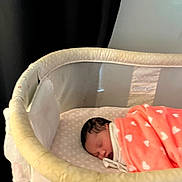 Emberlynn is registered to the contest to win money with this photo: baby, newborn, sleeping, blanket, bassinet, infant, bed, cozy, soft, indoor, peaceful, cute, child, resting, wrapped, fabric, nursery, head, person, portrait