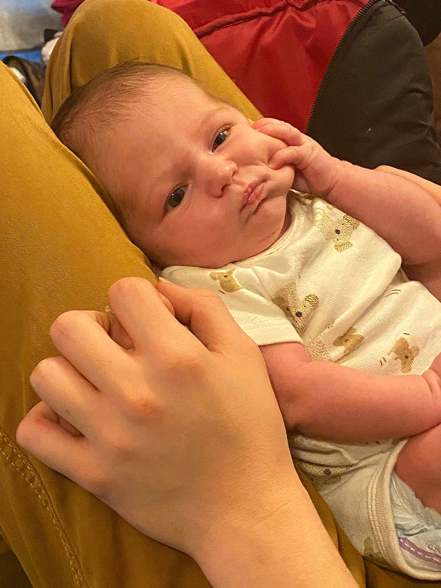 Evaleighn joined the competition — help win amazing prizes! baby, infant, hand, person, clothing, diaper, mustard_pants, skin, face, eyes, newborn, cute, holding, human, apparel, sitting, indoor, comfort, gentle, closeup