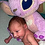 baby, infant, stuffed_animal, plush_toy, purple, soft_texture, cuddly, cute, newborn, face, skin, child, toy, indoor, blanket, lying_down, small, adorable, comfort, closeup