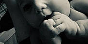 Evaleighn is registered to the contest to win money with this photo: baby, infant, close_up, black_and_white, face, hands, chubby_cheeks, curious_eyes, lying_down, indoor, skin, portrait, cute, newborn, child, human, expression, soft_light, person, young