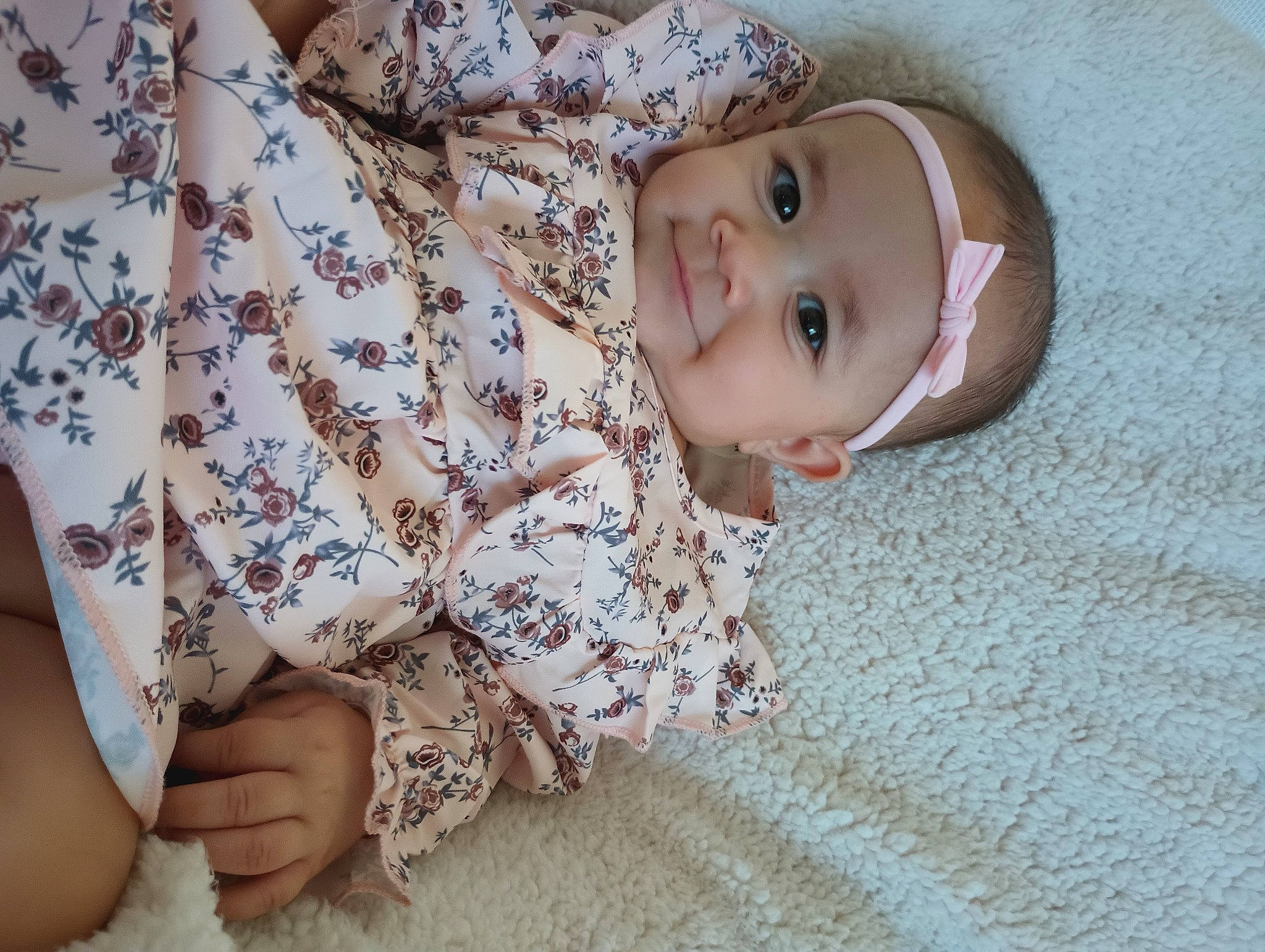 Helena is registered to the contest to win money with this photo: baby, baby_toddler_clothing, child, comfort, finger, flooring, grass, happy, headwear, human_leg, linens, nail, nose, pattern, person, sitting, skin, sleeve, smile, textile