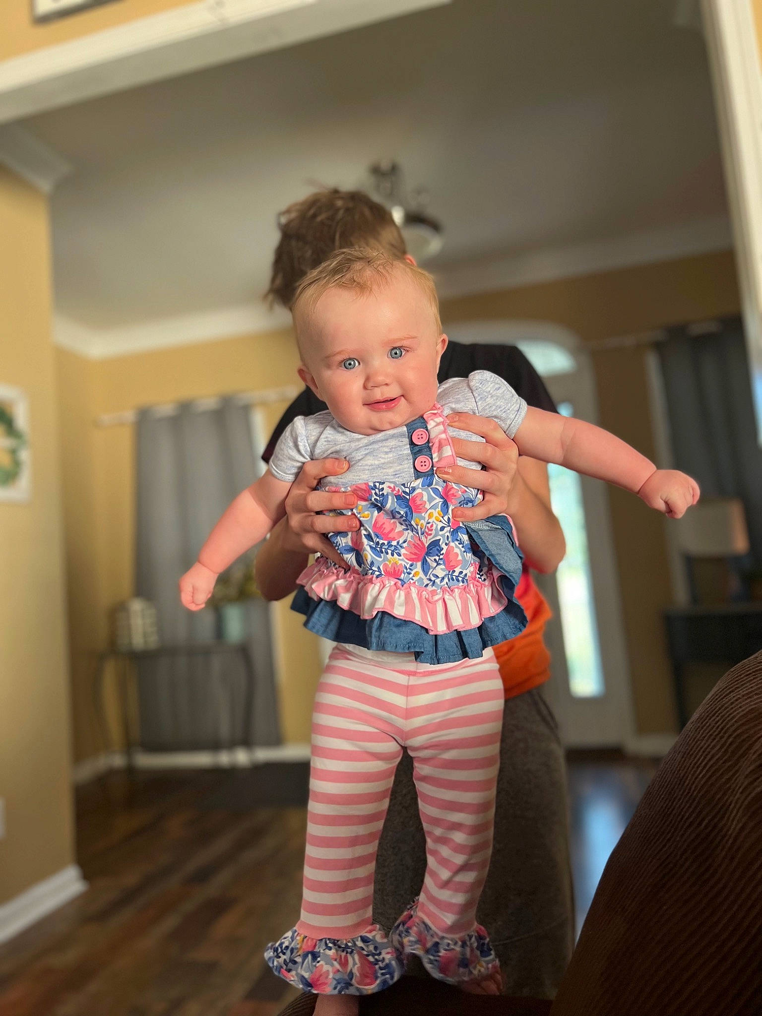 Idalia is registered to the contest to win money with this photo: abdomen, baby, baby_toddler_clothing, event, floor, flooring, fun, gesture, happy, hardwood, human_leg, leg, pattern, person, sleeve, t_shirt, thigh, toddler, trunk, waist