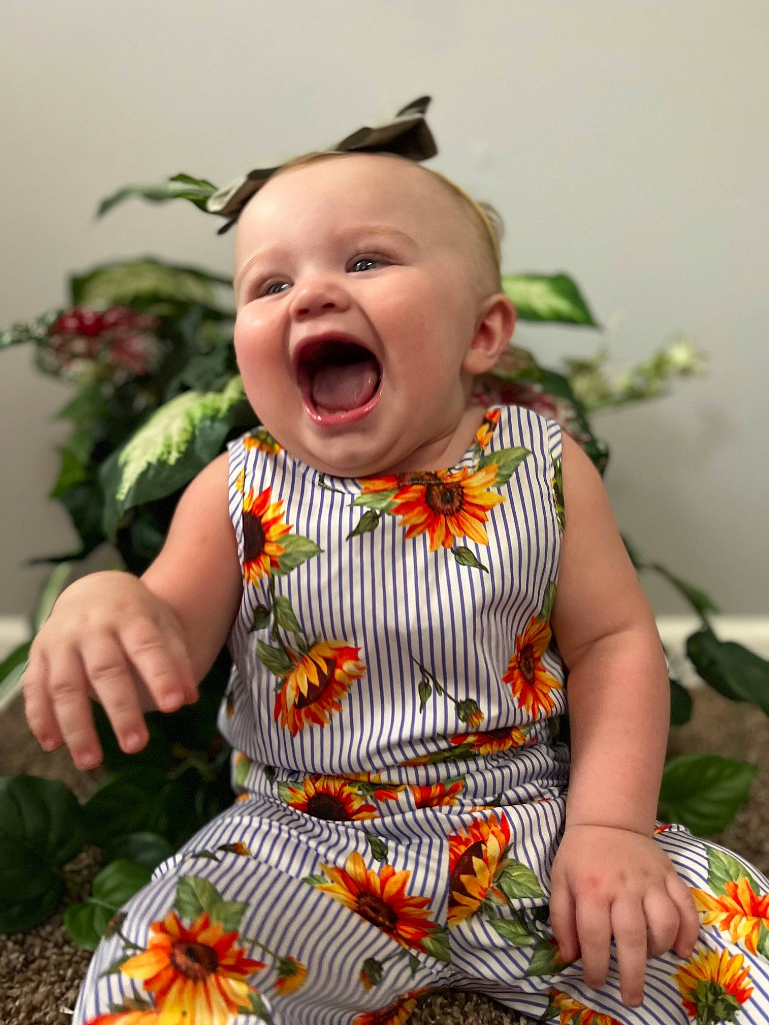 Idalia joined the competition — help win amazing prizes! baby, baby_toddler_clothing, child, dress, eye, floral_design, fun, grass, happy, iris, orange, pattern, people_in_nature, person, plant, sitting, skin, sleeve, smile, t_shirt