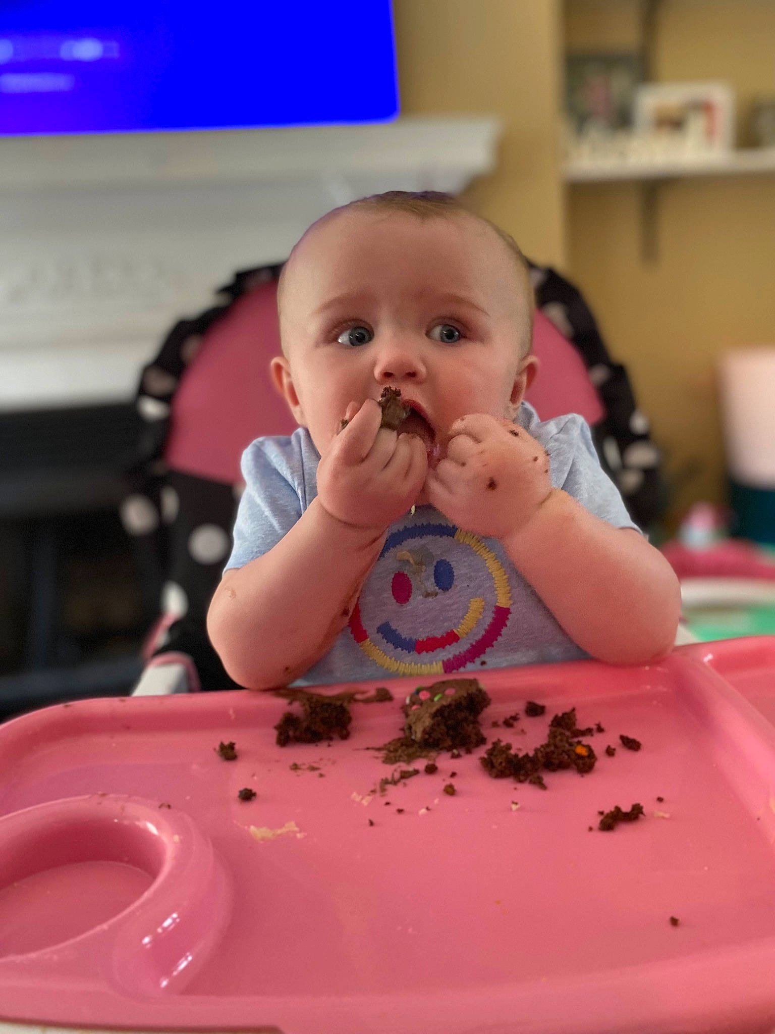 Idalia is registered to the contest to win money with this photo: baby, baby_playing_with_food, chair, cheek, child, dishware, face, facial_expression, finger, food, food_craving, lip, mouth, person, pink, plate, skin, standing, table, tableware