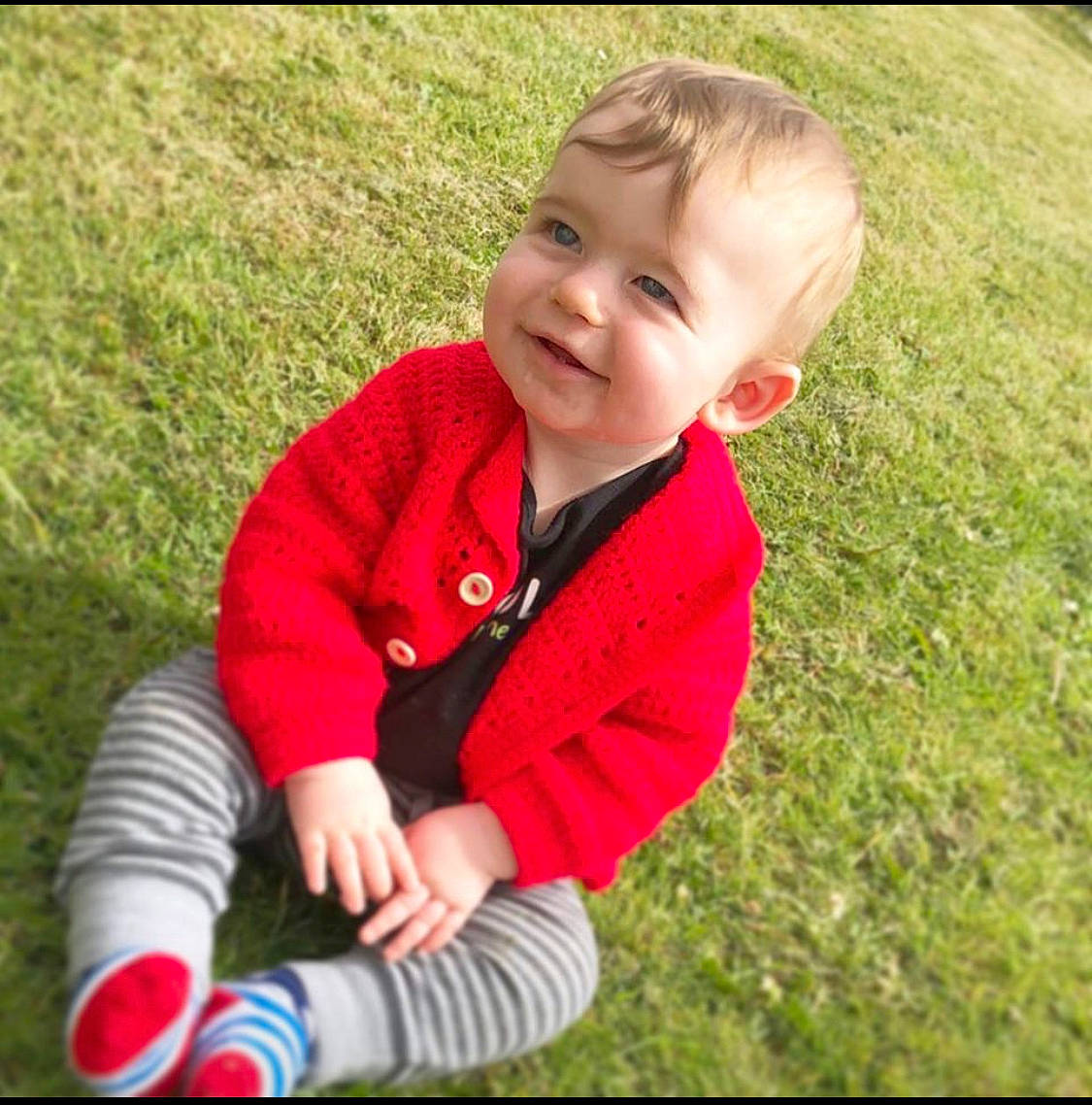 Jj is registered to the contest to win money with this photo: baby, cheek, child, cool, grass, happy, lawn, nose, outerwear, person, photography, plant, play, product, red, sitting, skin, sleeve, smile, t_shirt