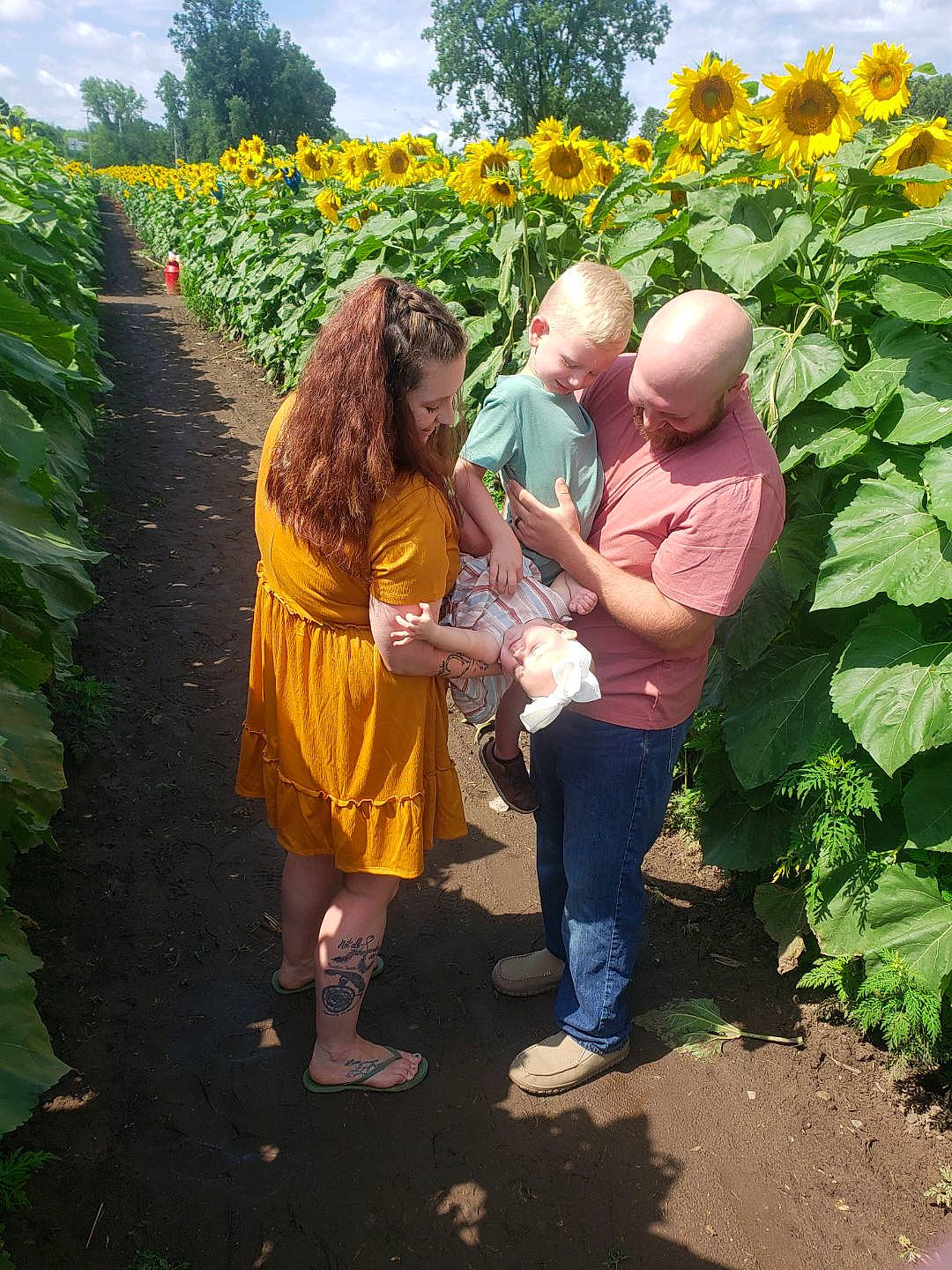 Easton is registered to the contest to win money with this photo: agriculture, annual_plant, botany, cloud, event, field, flower, flowering_plant, garden, grass, happy, landscape, leisure, people_in_nature, person, plant, plantation, shrub, sky, spring