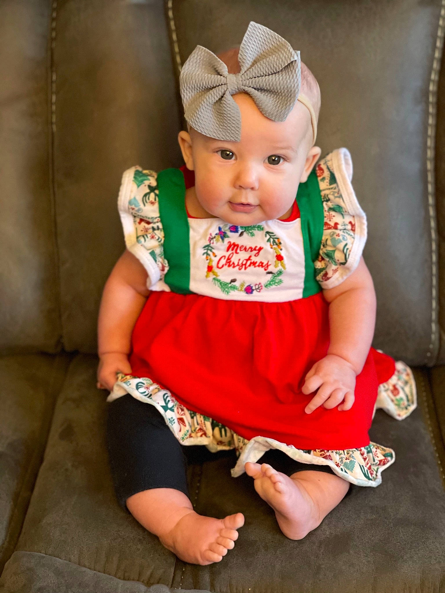 Katherine is registered to the contest to win money with this photo: baby, baby_toddler_clothing, cheek, costume_accessory, day_dress, doll, embellishment, foot, hair_accessory, hand, headband, headgear, headpiece, headwear, one_piece_garment, peach, person, sitting, toe, toy