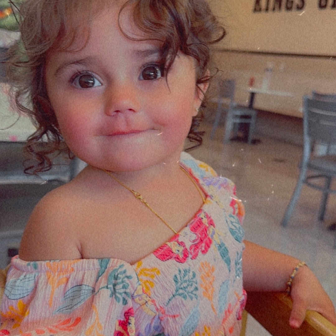 Inara Ali is registered to the contest to win money with this photo: accessories, baby, chair, clothing, diningtable, dress, face, furniture, happy, head, indoors, jewelry, necklace, person, photography, portrait, shorts, smile, table, wood