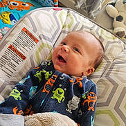 Kaden joined the competition — help win amazing prizes! baby, infant, smile, onesie, colorful_clothing, blanket, baby_gym, stuffed_animal, cushion, patterned_fabric, face, happy, indoor, child, cute, fun, playful, cozy, nursery, soft_toys