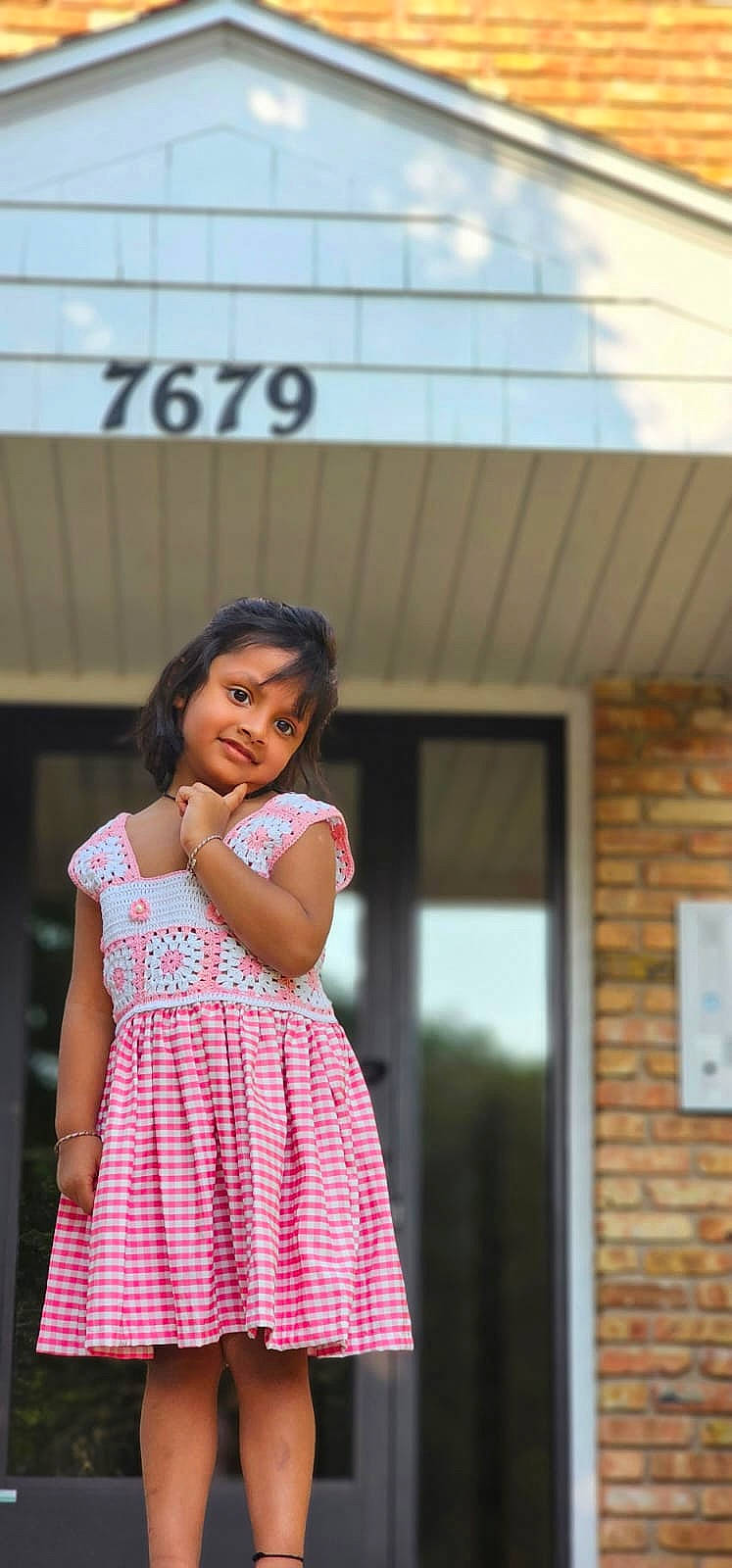 Advika is registered to the contest to win money with this photo: brickwork, day_dress, dress, entertainment, event, fashion_design, flash_photography, formal_wear, fun, happy, human_leg, joy, leisure, magenta, performing_arts, person, plaid, sitting, thigh, toddler