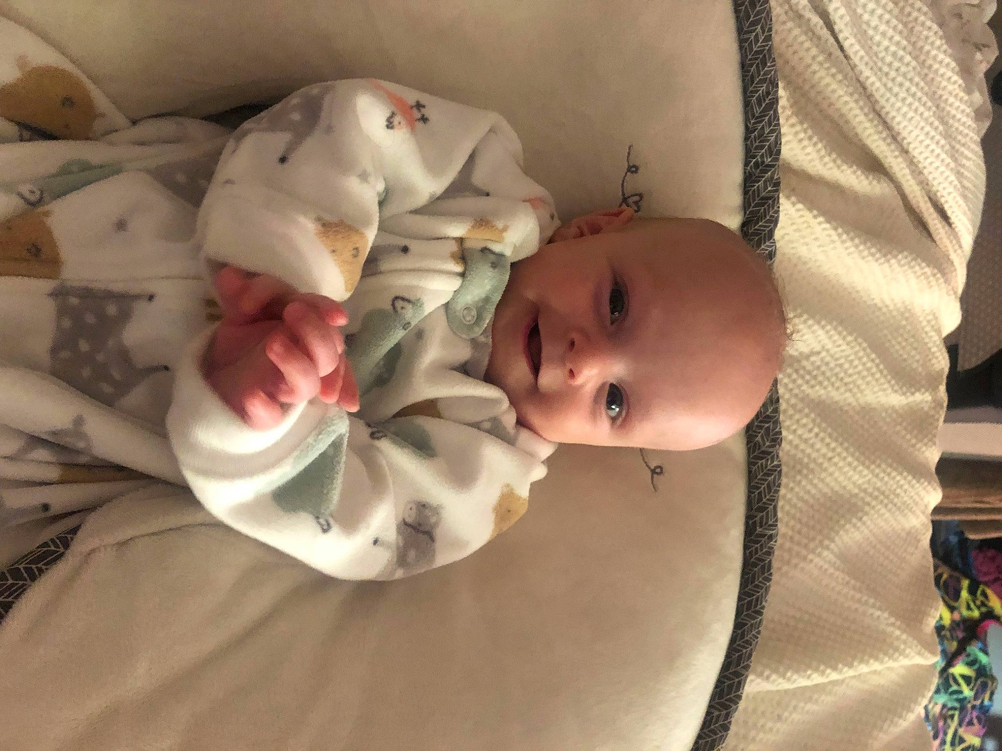 Albert is registered to the contest to win money with this photo: baby, baby_carriage, baby_products, baby_safety, baby_toddler_clothing, cheek, child, comfort, eye, hat, head, human_body, iris, linens, lip, pattern, person, room, skin, smile