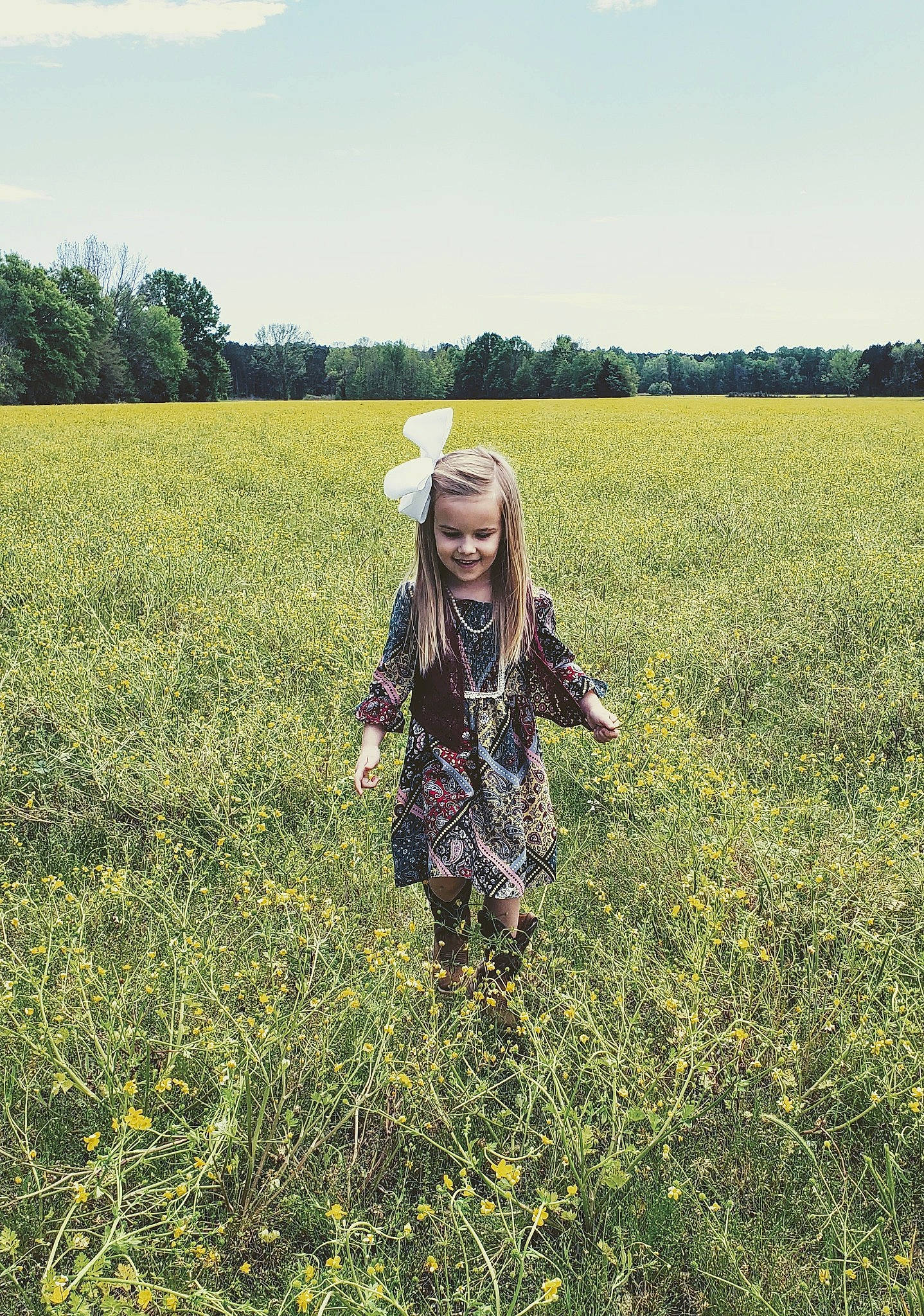 Brylee joined the competition — help win amazing prizes! agriculture, clothing, cloud, flower, flowering_plant, grass, grass_family, grassland, happy, hat, joy, landscape, meadow, natural_environment, natural_landscape, people_in_nature, person, plant, prairie, sky
