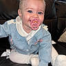 Billy participe au concours pour gagner de l'argent avec cette photo : baby, child, pacifier, blue_eyes, pink_bows, blue_cardigan, white_tights, sitting, couch, leather, cute, happy, smiling, indoor, portrait, infant, clothing, face, hand, foot