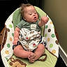 Karsten joined the competition — help win amazing prizes! baby, infant, child, portrait, sitting, bouncer, baby_chair, green_clothing, monkey_pattern, polka_dots, indoors, home, face, head, arms, legs, feet, raised_fist, blanket, adorable