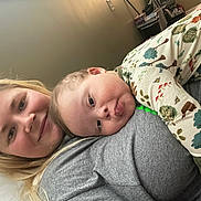 Karsten joined the competition — help win amazing prizes! affection, baby, bedroom, casual_clothing, child, closeup, cozy, expression, forest_print, hair, human_face, indoor, lying_down, pajamas, parent_and_child, portrait, relaxation, skin, smile, woman
