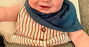 Oliver is registered to the contest to win money with this photo: baby, infant, smiling, face, blue_bib, striped_clothing, baby_seat, happy, cute, child, sitting, skin, head, eyes, mouth, expression, indoor, closeup, person, portrait