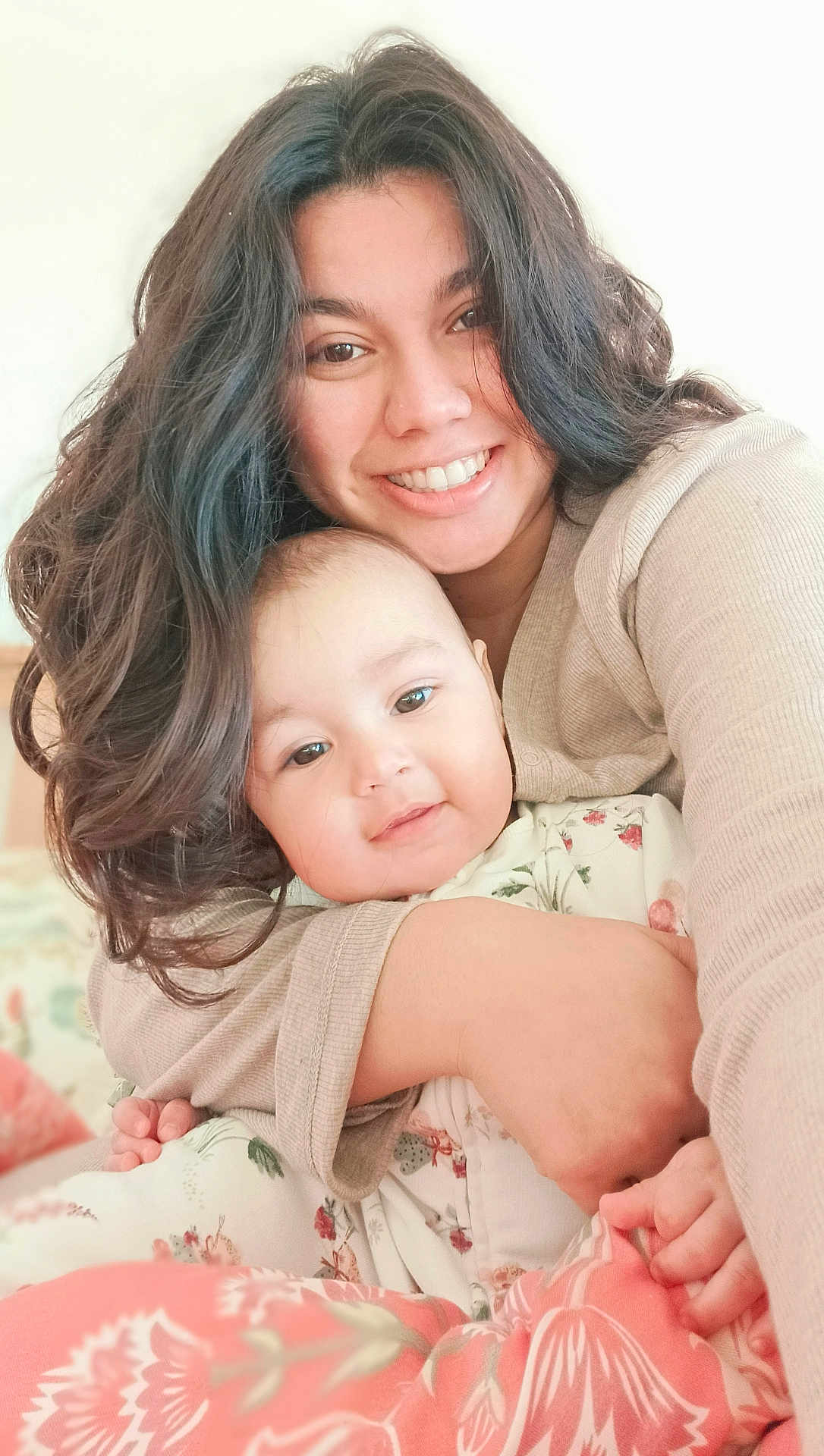 Komal joined the competition — help win amazing prizes! woman, baby, smile, hug, love, cozy, indoor, portrait, face, person, child, family, cuddle, long_hair, floral_pattern, soft_light, warmth, comfort, expression, clothing