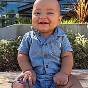 Joshua joined the competition — help win amazing prizes! baby, child, smiling, denim, romper, outdoor, sunlight, wooden_surface, building, greenery, happy, portrait, sitting, cute, infant, casual_clothing, daylight, nature, human, baby_boy
