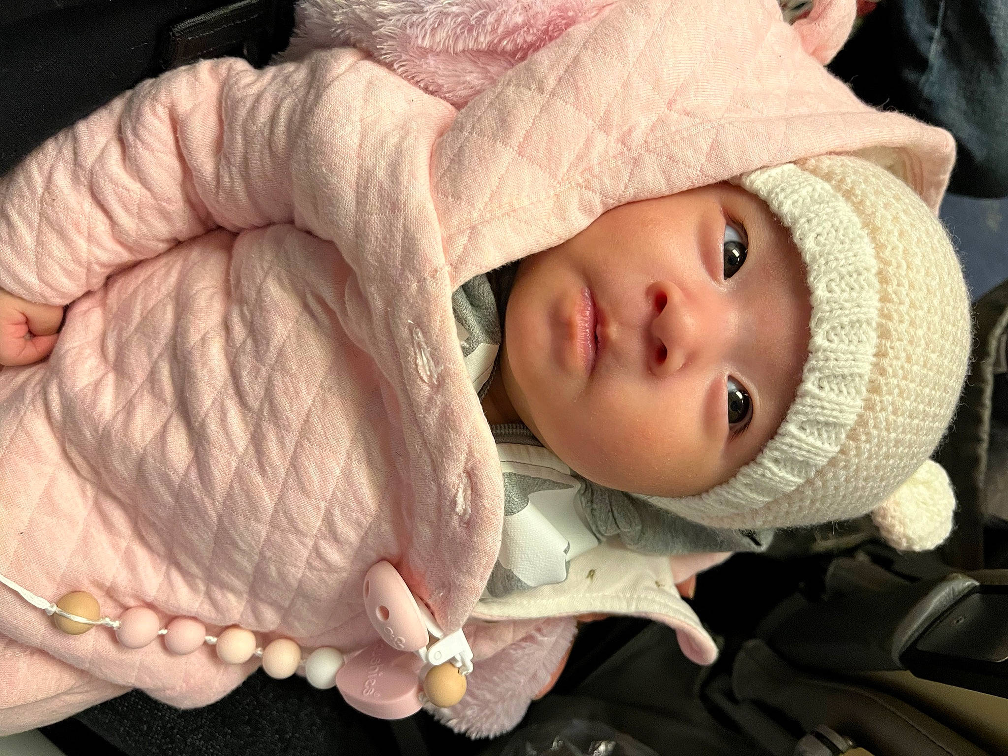 Kelly is registered to the contest to win money with this photo: baby, cap, cheek, child, chin, comfort, eyelash, facial_expression, finger, gesture, headwear, human_body, lip, mammal, mouth, nose, person, skin, textile, toddler