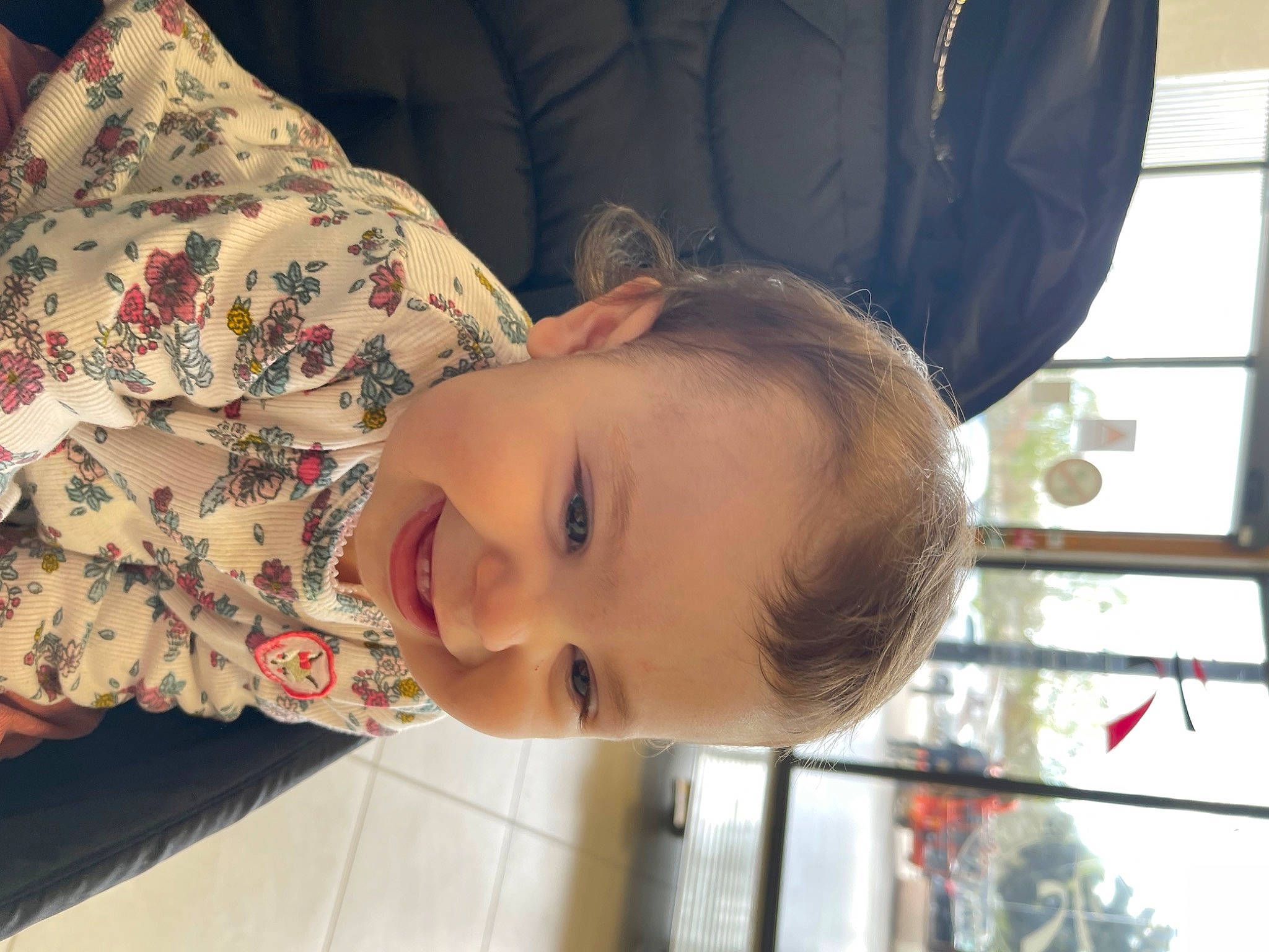 Emmy participe au concours pour gagner de l'argent avec cette photo : baby, baby_toddler_clothing, cheek, child, chin, comfort, dress, eye, happy, lip, neck, nose, pattern, person, plant, skin, smile, toddler, tree, window