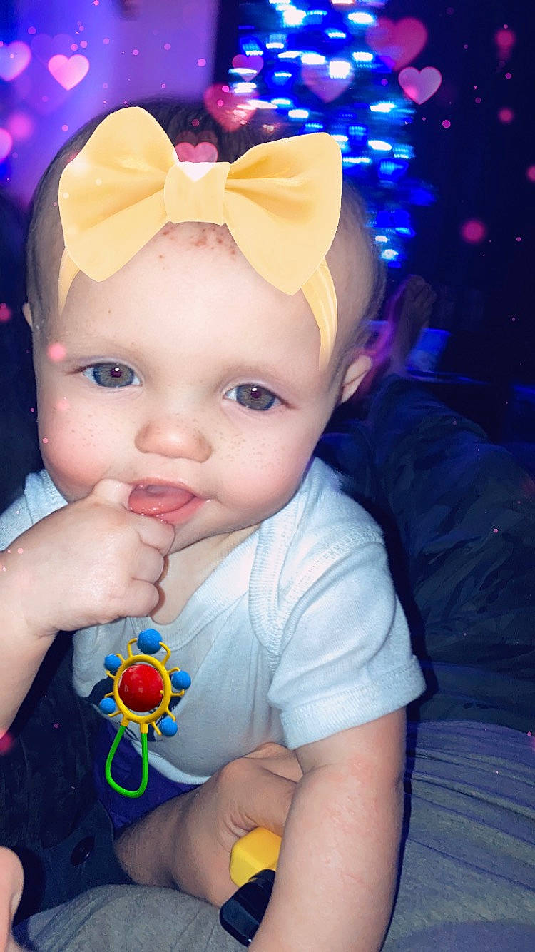 Riley is registered to the contest to win money with this photo: azure, baby, baby_toddler_clothing, blue, cheek, doll, ear, eye, fun, happy, headwear, iris, lip, nose, organ, party_hat, person, pink, purple, skin