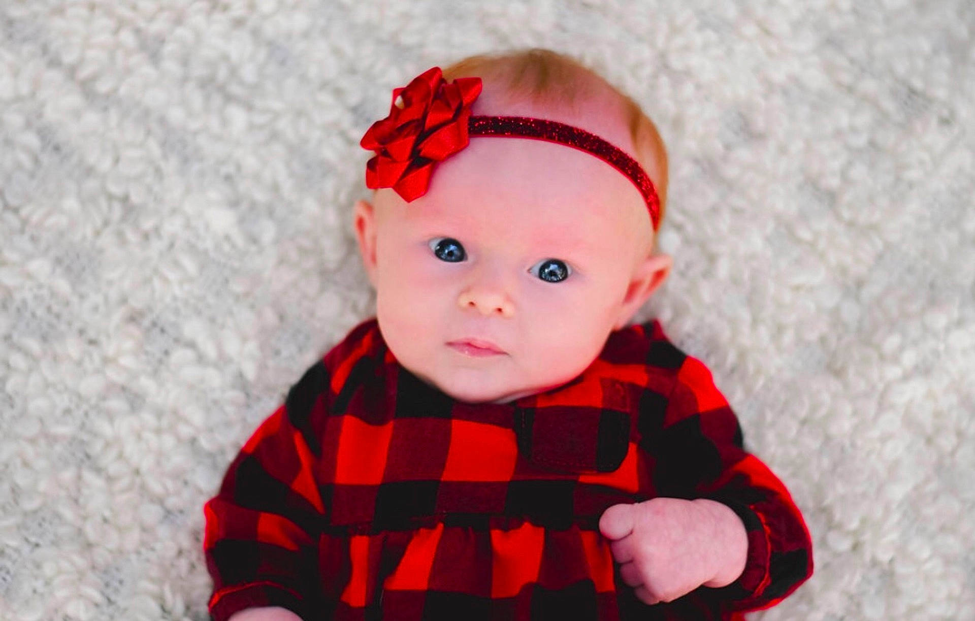 Macie is registered to the contest to win money with this photo: cheek, child, design, hair_accessory, headband, headgear, infant, pattern, person, plaid, red, skin, smile, tartan, textile, toddler