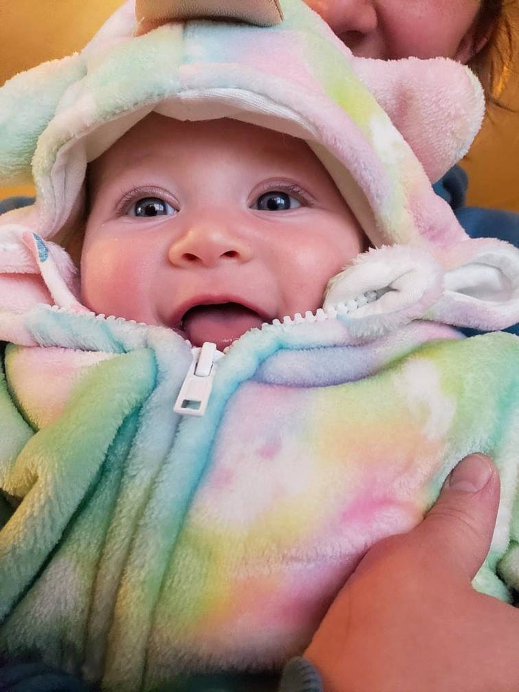 Wynonna is registered to the contest to win money with this photo: baby, baby_products, baby_toddler_clothing, cap, cheek, comfort, eyebrow, eyelash, finger, gesture, grass, happy, headwear, iris, linens, lip, nail, person, pink, skin