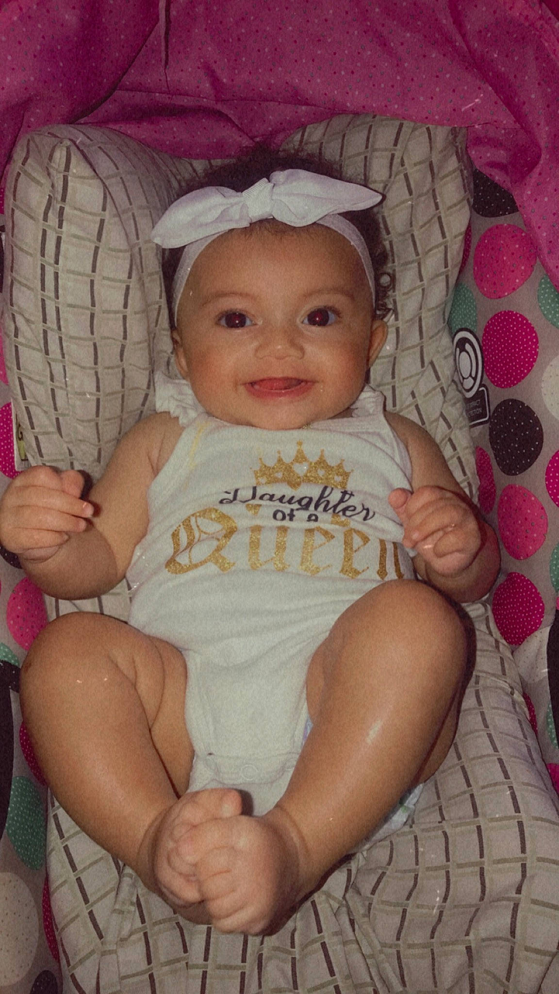 Cleo is registered to the contest to win money with this photo: baby, baby_toddler_clothing, cheek, child, comfort, eye, face, facial_expression, finger, fun, happy, head, headwear, iris, joy, lap, organ, person, pink, skin