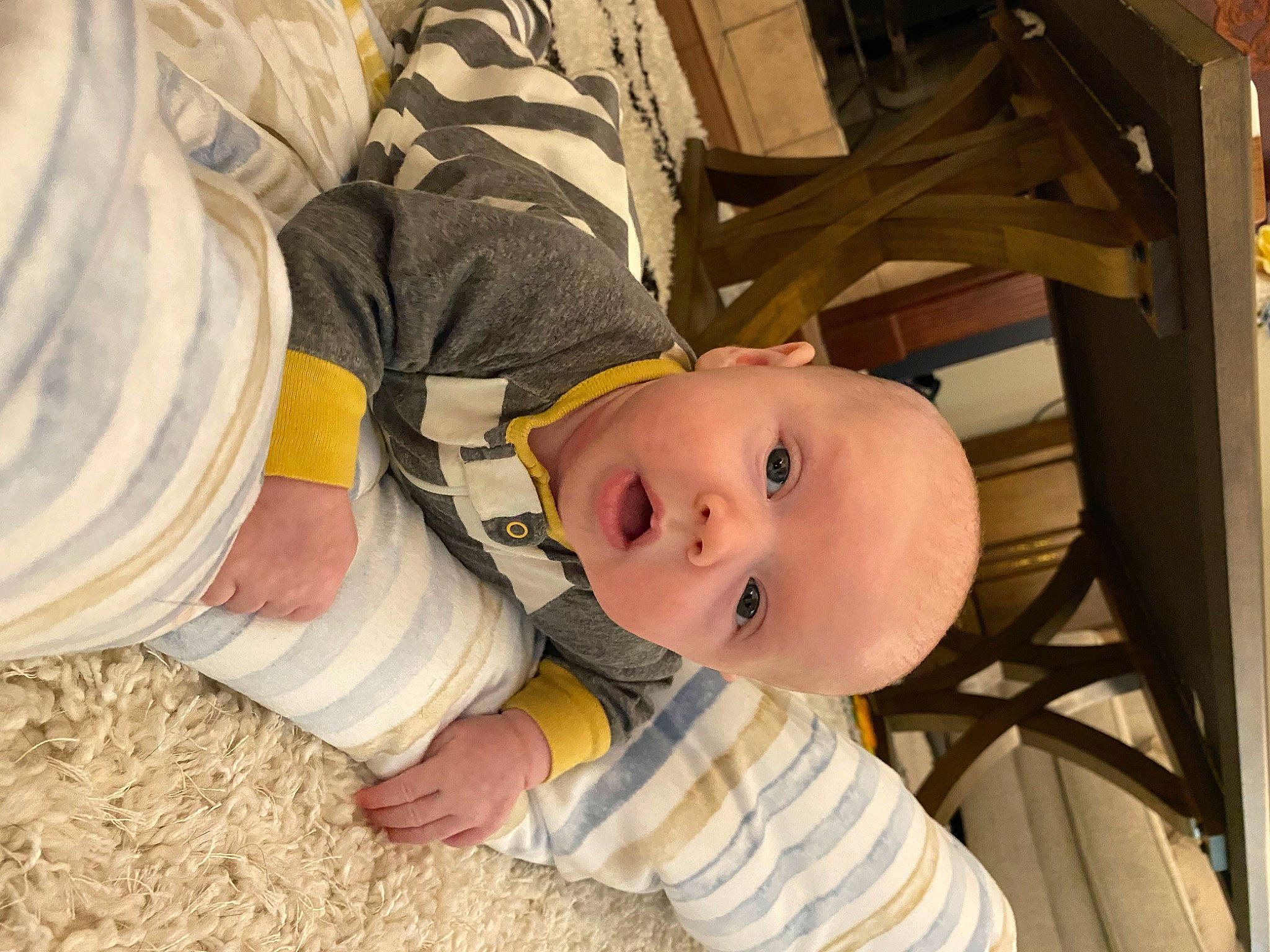 Grayson is registered to the contest to win money with this photo: baby, baby_products, baby_safety, baby_toddler_clothing, cheek, child, comfort, flooring, foot, fun, grass, hardwood, person, product, sitting, sleeve, smile, surprise, thumb, toddler