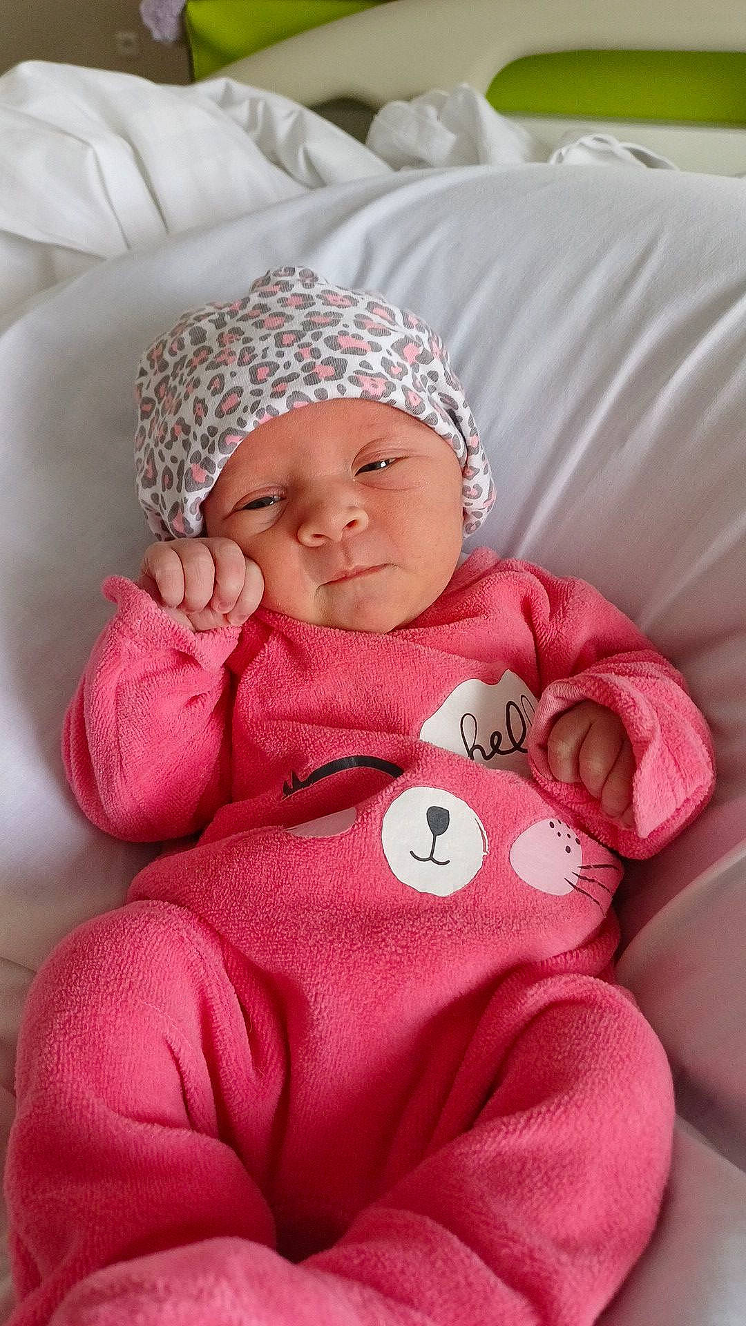 Lina participe au concours pour gagner de l'argent avec cette photo : baby, baby_products, baby_sleeping, baby_toddler_clothing, carmine, cheek, child, comfort, finger, head, headgear, headwear, knit_cap, linens, magenta, person, pink, sitting, skin, sleeve
