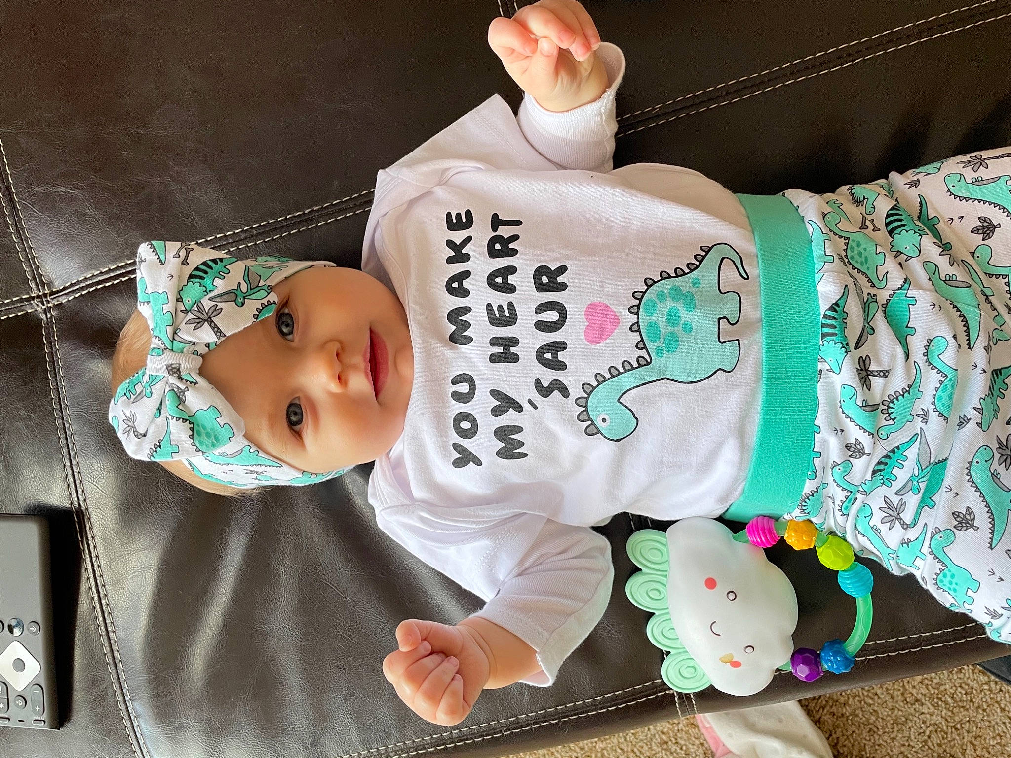 Beretta is registered to the contest to win money with this photo: baby, baby_products, baby_safety, baby_toddler_clothing, cheek, child, comfort, happy, hat, headwear, human_body, linens, pattern, person, pink, room, sitting, skin, sleeve, textile
