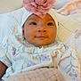 baby, blanket, blanket_wrap, child, clothing, cozy, curious, cute, face, floral, flower, headband, indoors, infant, newborn, person, pink, portrait, smile, soft_texture