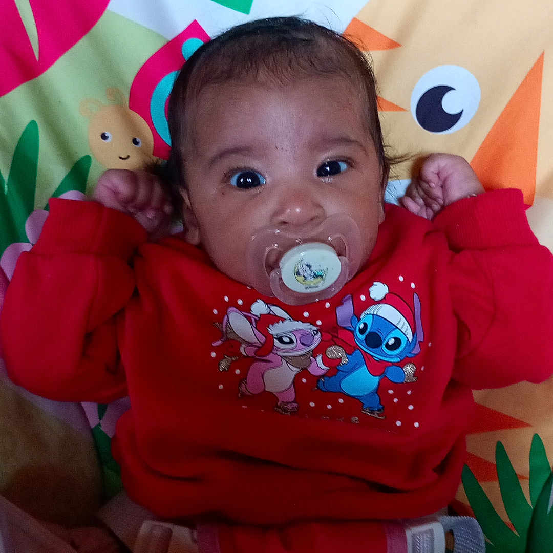 Sephora participe au concours pour gagner de l'argent avec cette photo : baby, baby_girl, cartoon_characters, child, clothing, colorful, cute, expression, face, indoors, infant, pacifier, person, play_mat, portrait, raised_hands, red_sweater, sitting, toy, young_child