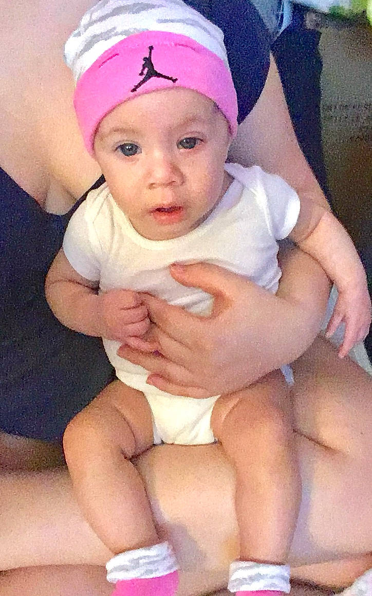 Gabby is registered to the contest to win money with this photo: baby, cheek, child, daughter, finger, hand, headgear, leg, person, pink, skin, smile, thumb, toddler