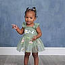Ahzonni joined the competition — help win amazing prizes! backdrop, barefoot, child, dress, fashion, floral_dress, full_body, hair_bows, hairstyle, happy, indoor, person, photography, pointing, portrait, smiling, standing, studio, toddler, wooden_floor