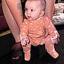 Harper joined the competition — help win amazing prizes! arm, baby, carpet, child, clothing, curious, cute, floor, footwear, furniture, hand, home, human, indoor, infant, onesie, person, skin, socks, tattoo