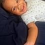 Ronald joined the competition — help win amazing prizes! baby, toddler, smiling, face, arm, hand, clothing, pattern, triangle, blanket, blue, skin, happy, lying_down, infant, portrait, child, cute, indoors, young
